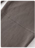 Close-up of gray sweatpants seam with visible reinforced stitching detail