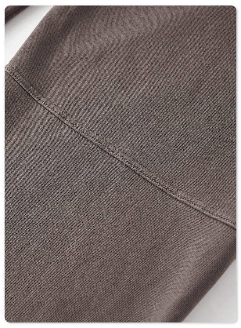 Close-up of gray sweatpants seam with visible reinforced stitching detail