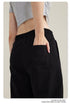 Rear view detail of black cargo pants with back pocket and cropped gray top