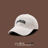 White baseball cap with navy COLORADO embroidery displayed against brown background, featuring UV protection and foldable design
