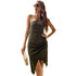 Studio shot of olive green asymmetric dress with side slit, styled with gold jewelry and sunglasses