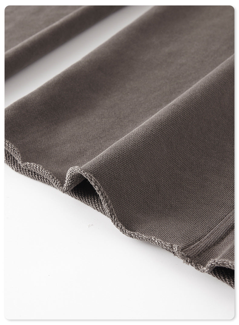 Close-up of gray sweatpants fabric showing texture and folded edge detail