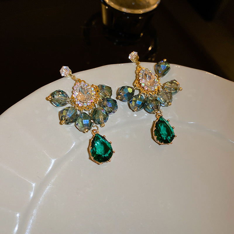 Intricate gold drop earrings with iridescent green crystal clusters, clear cubic zirconia, and a teardrop emerald stone pendant