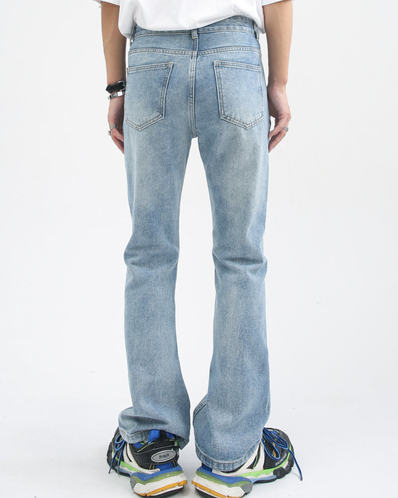 Distressed light blue wide-leg denim jeans with faded vintage wash