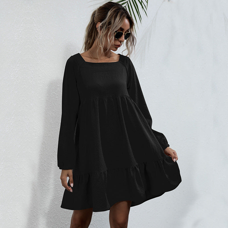 Black long-sleeve babydoll dress with square neckline, showcasing modern minimalist style for versatile wear