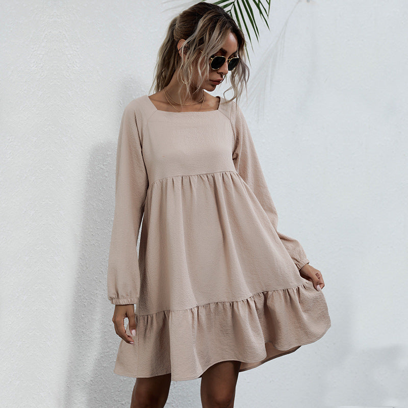 Beige long-sleeve babydoll dress with square neckline, creating soft and feminine aesthetic