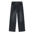 A pair of faded black wide-leg jeans displayed flat against a white background, featuring front pockets and a relaxed fit