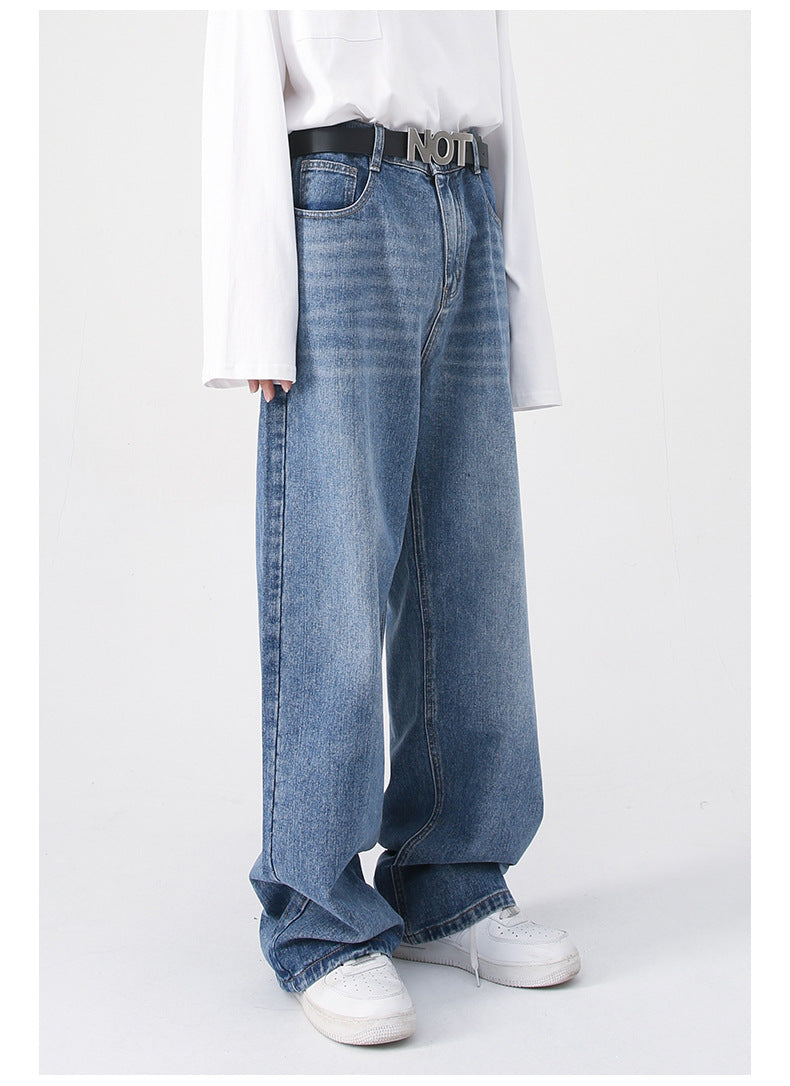 A side view of blue wide-leg jeans with a high waist and a "NOT" belt, paired with a white shirt and white sneakers