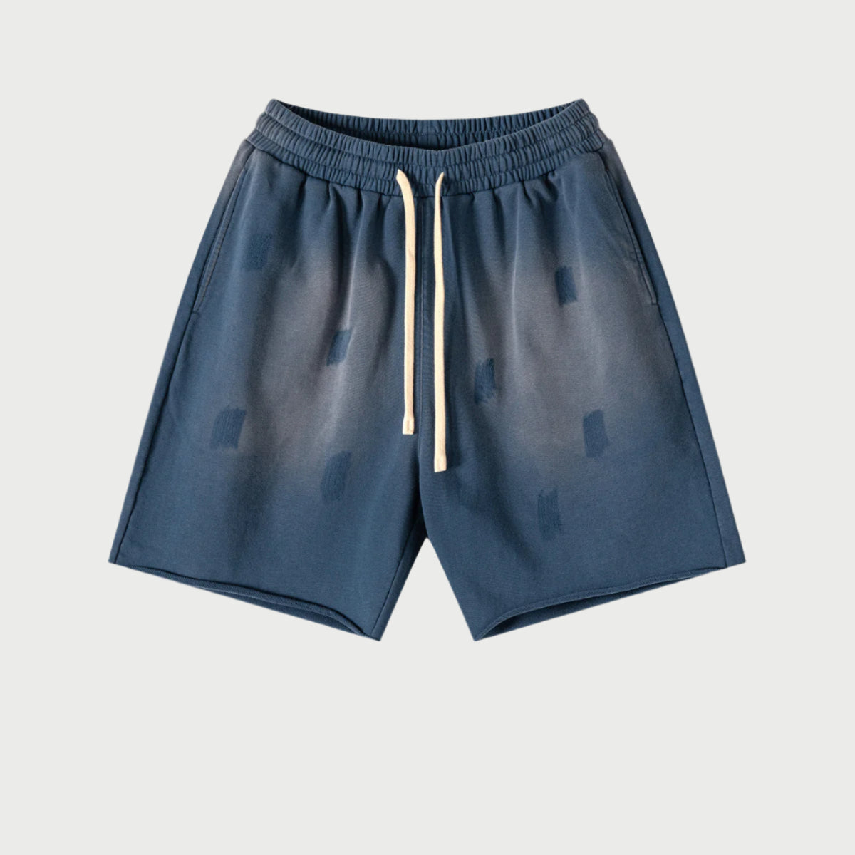 Navy blue drawstring shorts with elastic waistband and cream drawstrings displayed flat against light gray background