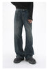 A model is wearing dark-wash wide-leg jeans with a black ribbed sweater and black quilted platform shoes, posing against a white backdrop