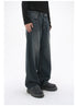 A model is standing in dark-wash wide-leg jeans and a black ribbed sweater, showing a side profile against a plain white background