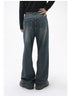 A model is showing the back view of dark-wash wide-leg jeans, standing with one hand on the hip against a white backdrop