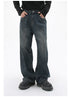 A model is posing in dark-wash wide-leg jeans with hands in pockets, paired with a black ribbed sweater and black platform shoes