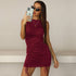 A woman taking mirror selfie in burgundy ruched mini dress with drawstring details, wearing slim cat-eye sunglasses