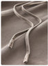 Close-up of grey drawstring cord on sweatpants against soft fabric background