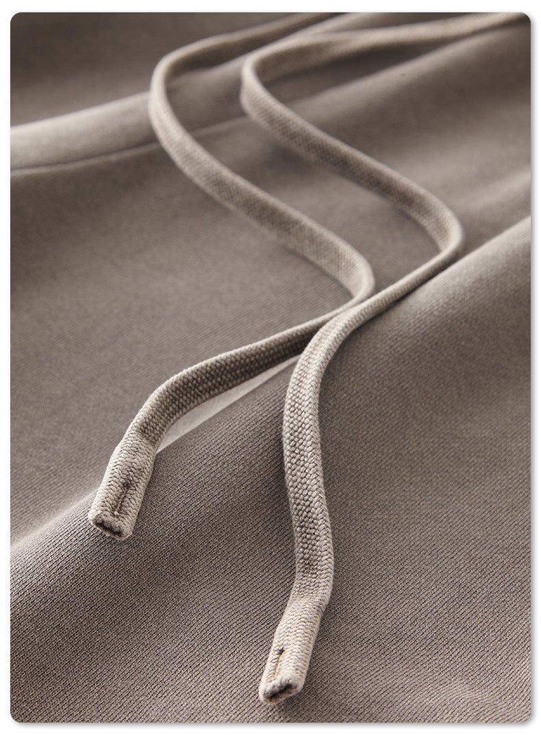 Close-up of grey drawstring cord on sweatpants against soft fabric background