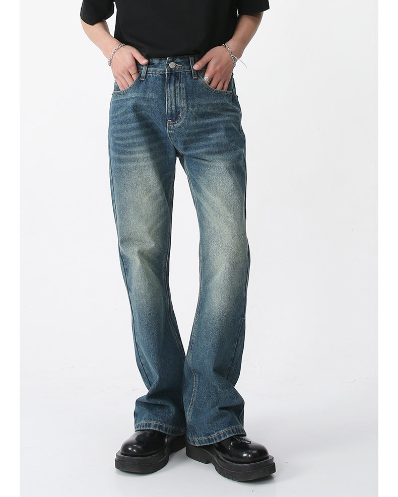 A model wearing vintage-wash straight-leg jeans with black tee, hands in pockets, styled with chunky platform shoes against white background