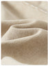 A close-up of soft beige fabric with a subtle texture and natural folds