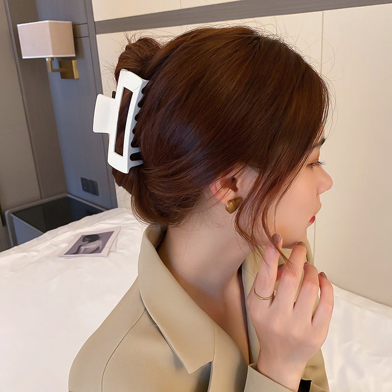 White and gold rectangular hair clip showcasing classic design for sophisticated hair management