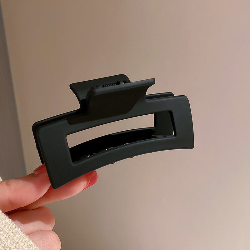 Large black hair claw clip with wide grip, designed for thick hair and effortless styling