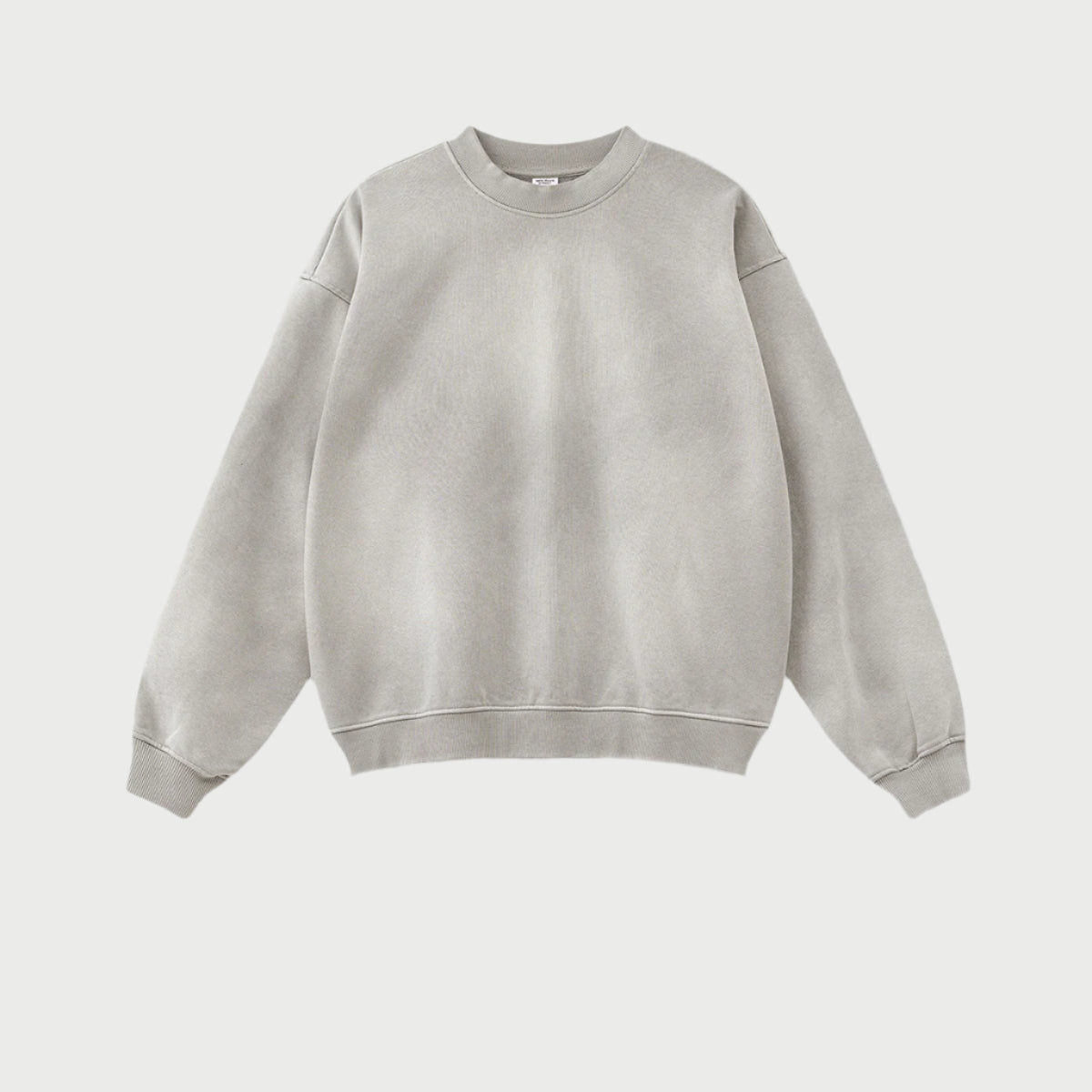 Product shot of light grey crewneck sweatshirt with ribbed collar and cuffs, showing relaxed fit