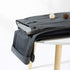 Gray dress pants neatly folded on white table with decorative elements, showing cuff detail with button closure