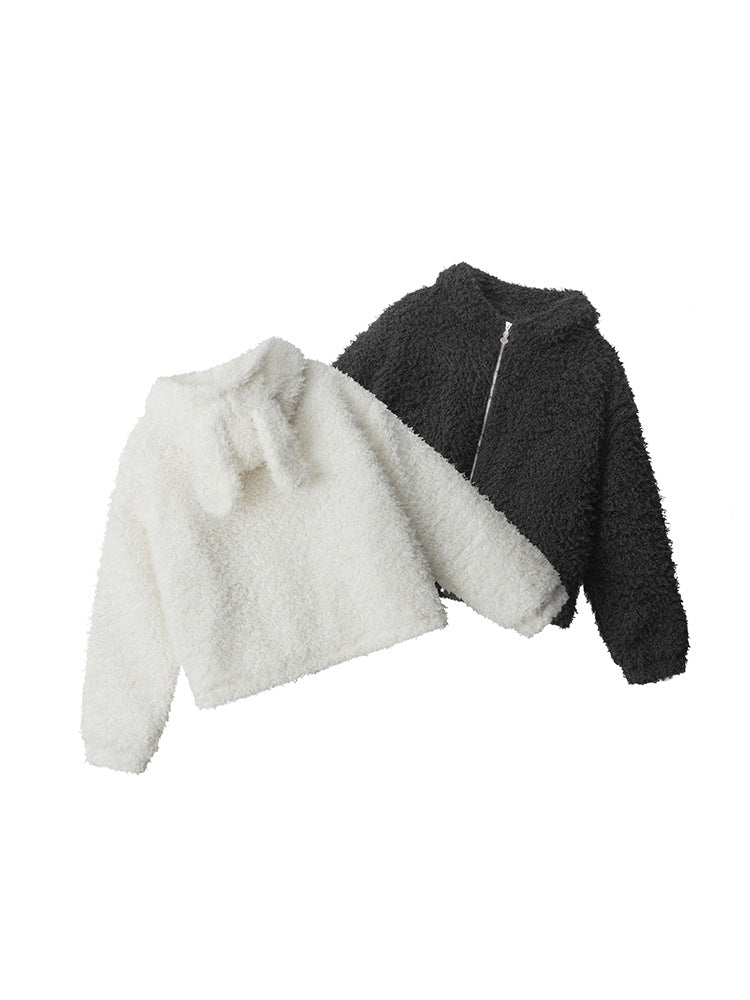 Product lineup showing white and black teddy jackets with zip front closure against white background