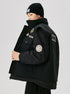 Three-quarter view of black winter coat with multiple decorative patches, flap pockets and ribbed cuffs