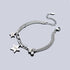 A detailed shot of the silver chain bracelet with dual star charms and small silver beads, laid flat on a reflective surface with an adjustable clasp.