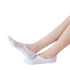 White no-show socks on feet showing seamless fit and breathable mesh panels against white background