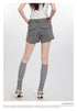 Back view of gray shorts with flap pockets, shown with white top and knee-high socks with heels