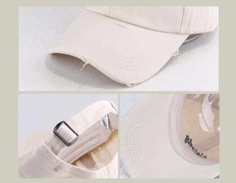 Close-up details of beige baseball cap showing adjustable strap and distressed brim texture