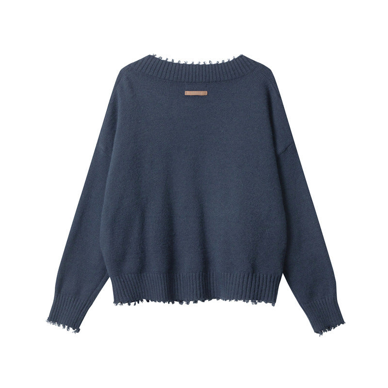 Back view of navy V-neck sweater with simple clean back design, ribbed hem and cuffs with distressed edges.