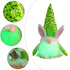 Close-up of a green LED bunny gnome plush toy with a sequined hat, featuring glowing beard and battery compartment.