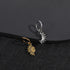 Gold sun and silver moon ear charms on black surface