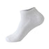 Single white ankle sock – A single white ribbed ankle sock isolated on a white background, displaying its breathable material and stretchable design