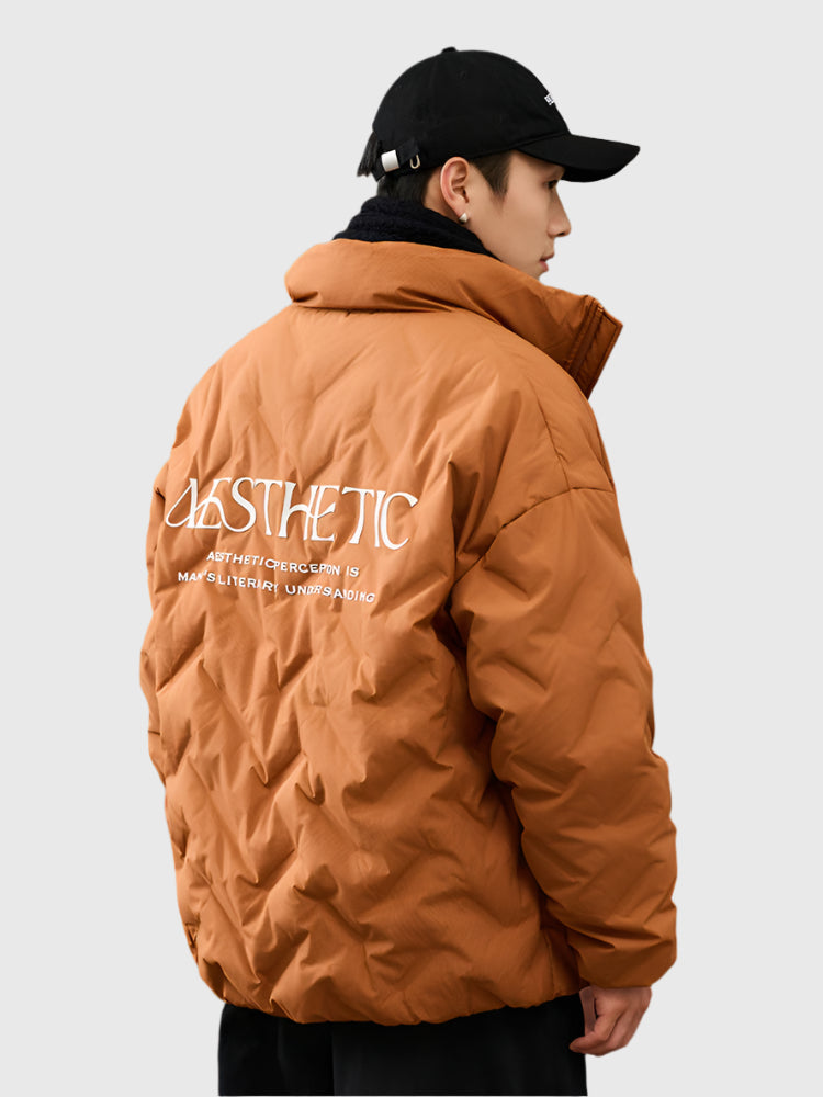Side profile of man in camel brown Aesthetic quilted jacket showing back text detail and logo branding against white background