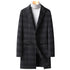 Black plaid overcoat with a notched lapel, worn over a gray turtleneck sweater