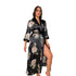 Black and white leopard print satin robe with black trim, worn by woman with necklace and earrings