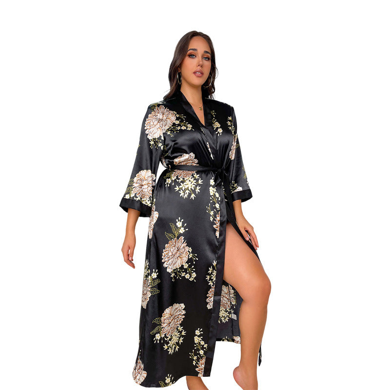 Black and white leopard print satin robe with black trim, worn by woman with necklace and earrings