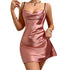 Close-up of pink satin dress with cowl neckline and rhinestone bracelet