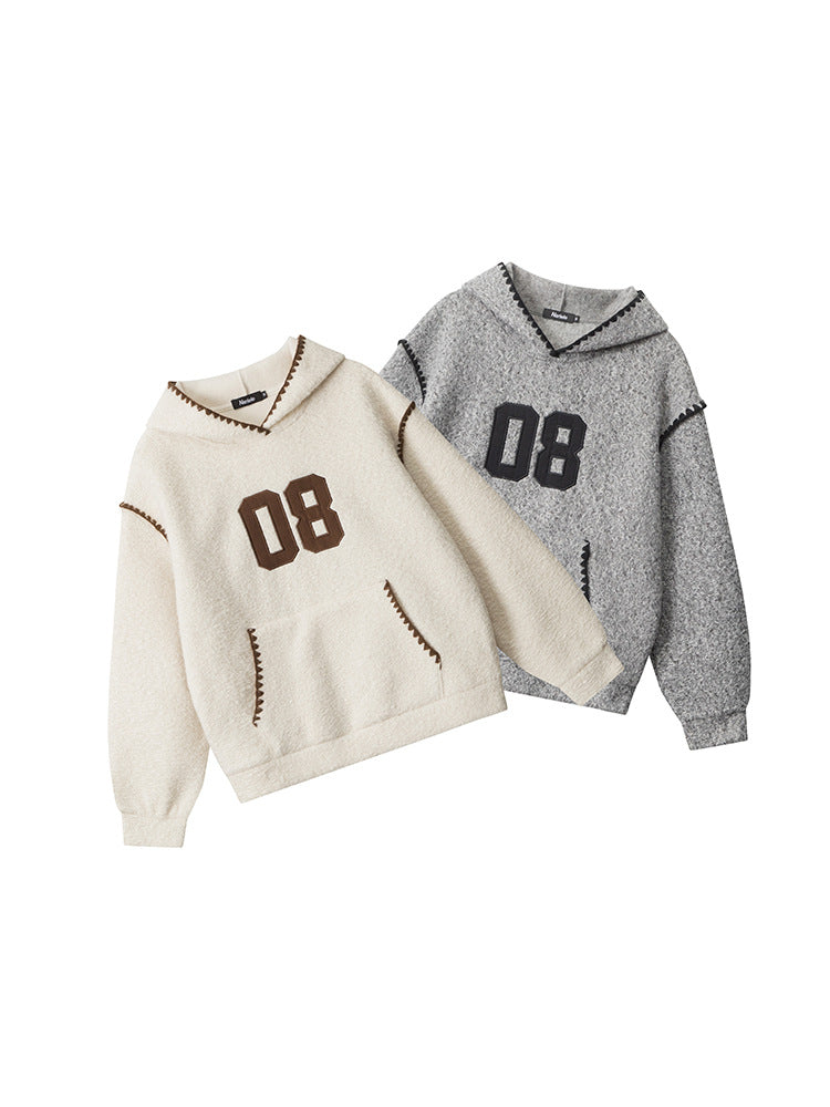 Two varsity-style hoodies with '08' appliqué - one in cream with brown trim and one in heather grey with black trim, featuring contrast whipstitch detailing and kangaroo pockets