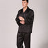 Model standing in black striped silk pajama set with collared shirt, chest pocket and full-length pants