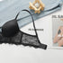 A black push-up bra with adjustable straps and scalloped lace trim displayed on white surface with denim fabric and Jil Sander catalog