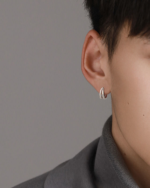Double-band silver earring worn on ear, profile view
