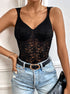 Close-up of V-neck lace bodysuit styled with distressed light-wash jeans and black belt.