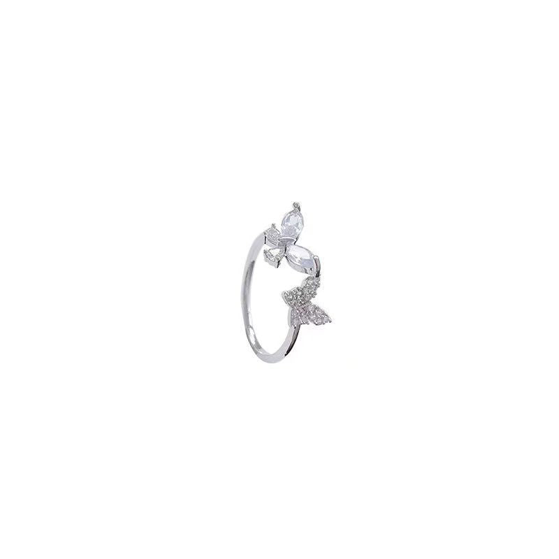 Minimalist silver butterfly ring with crystal embellishments against a white background