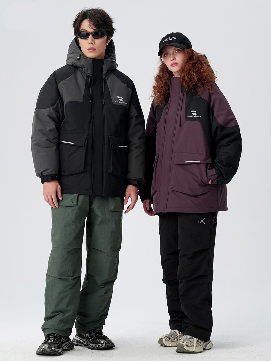 Two models standing together wearing All Drifting technical jackets - black with gray panels and plum with black panels on white background