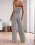 Back view of a woman in a black and white striped bandeau and wide-leg pants, highlighting the fit and design from behind.