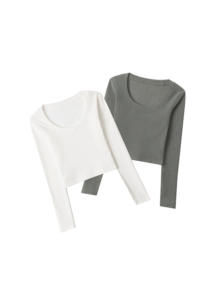 Two long-sleeve crop tops laid flat - one in white and one in gray, featuring scoop necklines and fitted silhouette